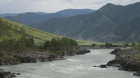 The mountain river flows in solidified, petrified lava. The mountains. 動画素材 119995891