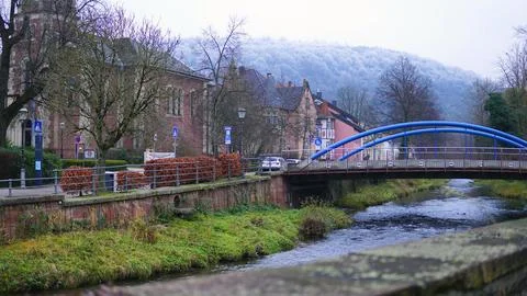 A mountain river flows through the city, you can see a bridge over the river and Stock Photos