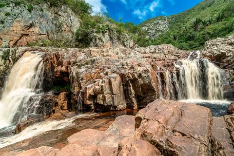 A mountain river flows through rocks in South America Stock Photos