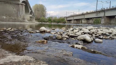 Mountain river flows through the stones under the bridge Stock Footage 152944404
