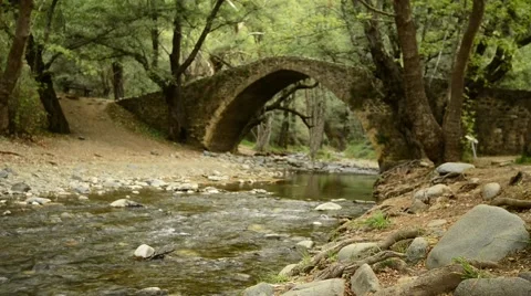 Mountain river flows under the medieval Venetian bridge Stock-Footage 63399641