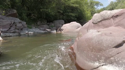 A mountain river flows. Water gushes between stones, rapids. Video stock 136249644