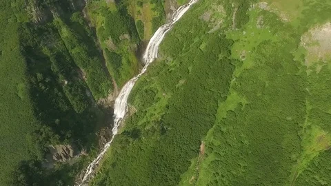 Mountain river flows into a waterfall. View of the waterfall from the bird's Stock Footage 72654180