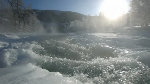 The mountain river flows in winter in a frost In slowmotion Stock Footage 85717993