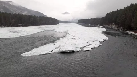 Mountain river in ice on the background of misty mountains Stock Footage 236835345