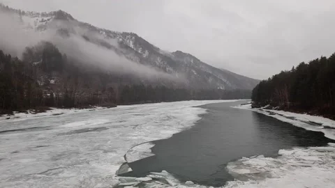 Mountain river in ice on the background of misty mountains Stock Footage 236835360