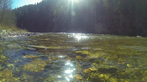 Mountain river landscape, clear water with glare and colored stones Stock Footage 67315953