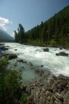 The mountain river in the mountains. Current through the gorge the river. S.. Stock Photos