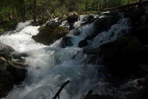 The mountain river in the mountains. Current through the gorge the river. S.. Stock Photos