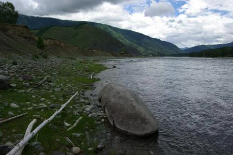 The mountain river in the mountains. Current through the gorge the river. S.. Stock Photos