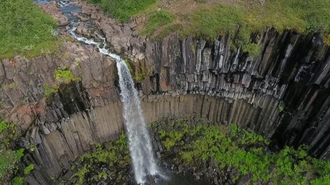 The mountain river moves through the valley and falls off the cliff. Andreev. Stock Footage 78114845