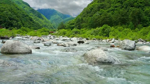 Mountain river with moving clouds in the background. Time lapse. Stock Footage 31285821