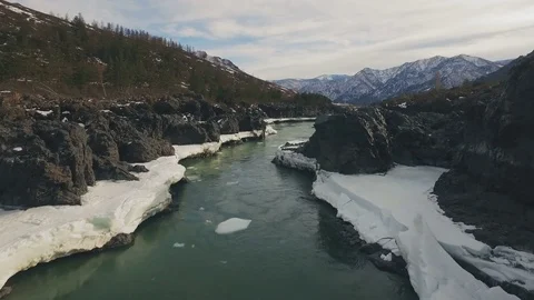 Mountain river opened from the ice in the spring, aerial Stock Footage 74087408