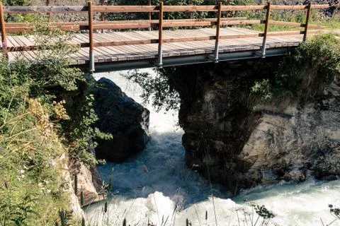 Mountain river passing under bridge Stock Photos