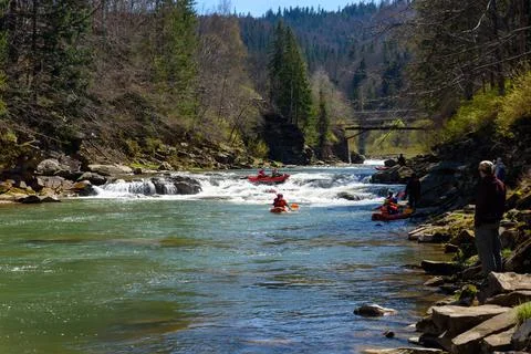 Mountain river rafting competition between teams Stock Photos