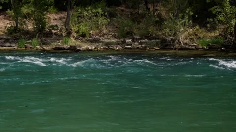A mountain river roars, with green trees in the background. Recreational activit Stock Footage 270085026