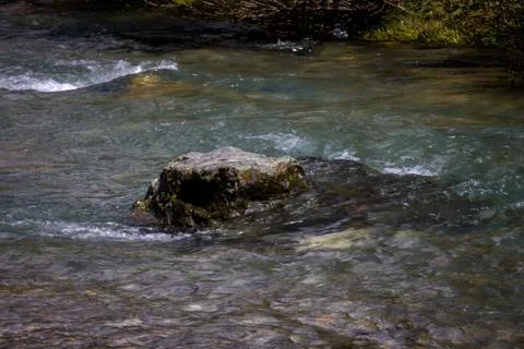 A mountain river with rock in it Stock Photos