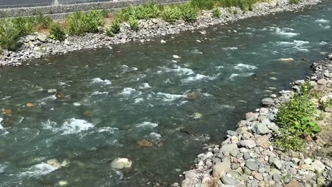 Mountain river running through stone rapids. Clean water flowing between river Stock Footage 215900680