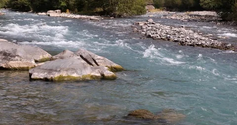 The mountain river runs in a stormy stream through the forest, bending stones Stock-Footage 119153039