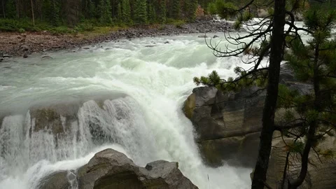 Mountain river rushing over rocks as rapids and small waterfall.  Stock Footage 140912904