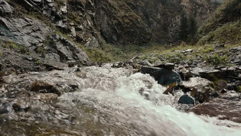 Mountain river rushing over rocky terrain Stock Footage 287900559