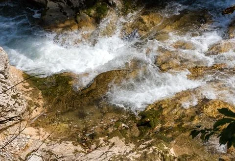 A mountain river with a rushing stream and waterfalls in the warm season in n Stock Photos