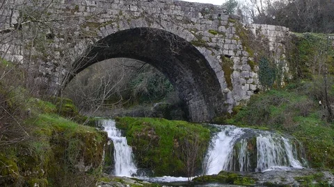 Mountain river slope under an old bridge Stock Footage 86953557