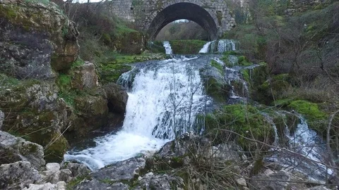 Mountain river slope under an old bridge Stock Footage 87062304