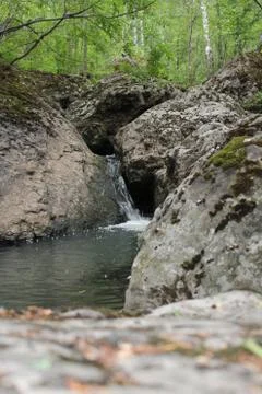 Mountain river - a small waterfall on a river with crystal clear water that 写真素材