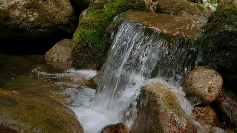 Mountain river stream water falls flowing slowmotion,natural fluid motion Stock Footage 161915644