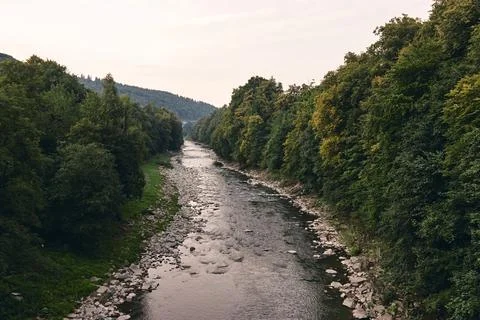 Mountain river surrounded by mountains. Sheer cliffs . blue clear water of th Stock Photos