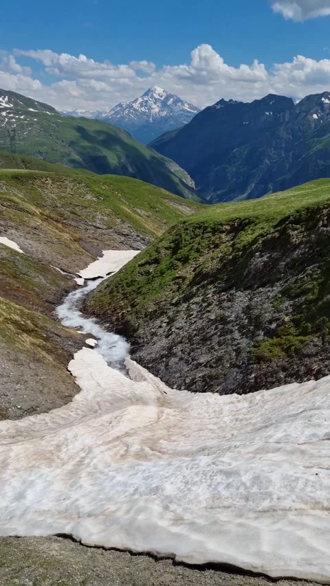 A mountain river in the Val Ferre valley in Italy with a rocky mountain range Video stock 284668459