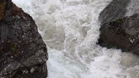 Mountain river water rushing between dark wet mossy rocks Stock Footage 341867107
