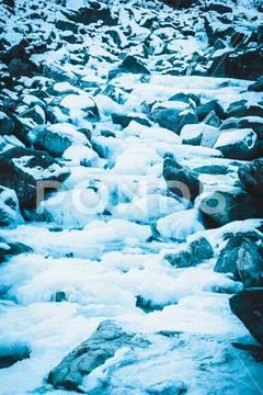 Mountain river in winter. Cold water flows among rocks. Journey onriver in mo Stock Photos