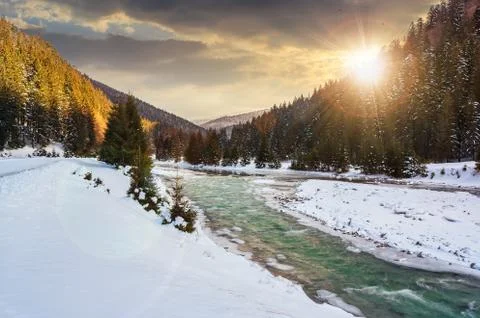 Mountain river in winter at sunset Stock Photos