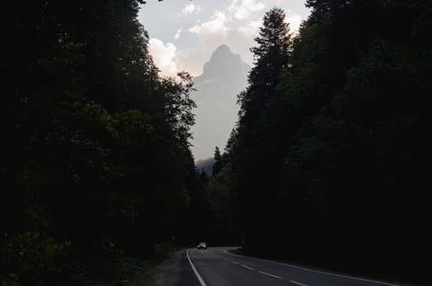 Mountain road in the autumn forest of the caucasus Stock Photos