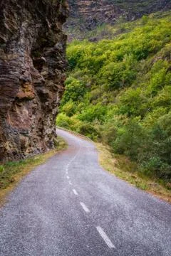 Mountain road between cliffs and wooded valleys Stock Photos