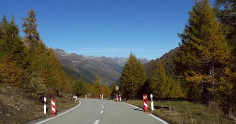 Mountain road, Cinema 4k view driving down on a alpine road, between autumn c Stock Footage 82708482