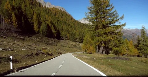 Mountain road, Cinema 4k view driving down on a alpine road, in a autumn colo Stock Footage 82708698