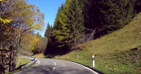 Mountain road, Cinema 4k view driving on a alpine road, in a autumn color for Stock Footage 83090635