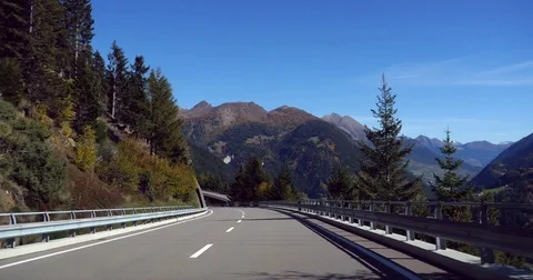 Mountain road, Cinema 4k view driving on a alpine road, in a autumn color for Stock Footage 83095791