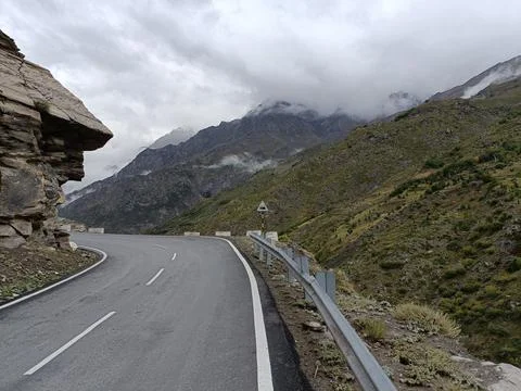 Mountain Road With Clouds Stock Photos