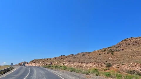 Mountain road curves through dry rocky terrain in eastern Turkey Stock Footage 343805338