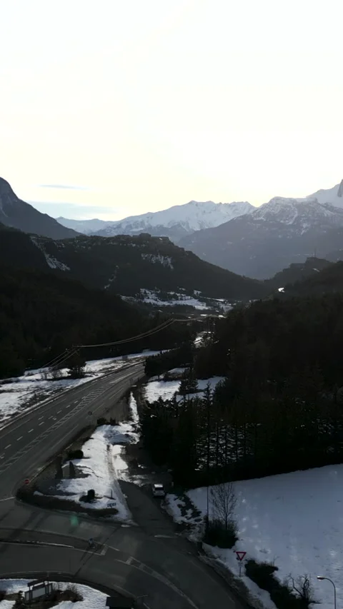 A mountain road is driven by several vehicles Video stock 275543819