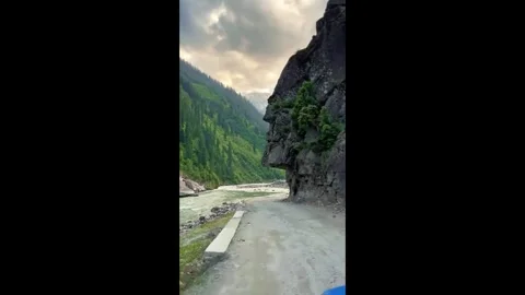 Mountain Road with Flowing Stream Stock Footage 314896262