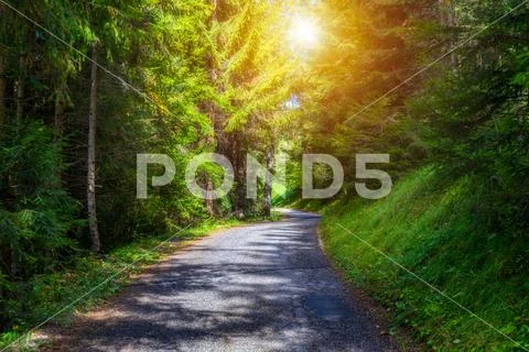 Mountain road. Landscape with rocks, sunny sky with clouds and beautiful asph Stock Photos