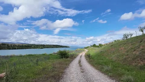 Mountain Road Leading Through Rugged Peaks and Valleys Stock Footage 336028093