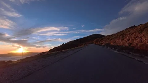Mountain road in the Mediterranean at sunset with low clouds in autumn Stock Footage 320103788