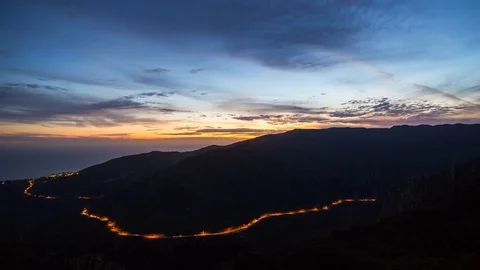 Mountain Road Passing Through a Canyon at Dusk Video stock 76852748