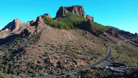 Mountain road snaking around rock formation Stock-Footage 231779754